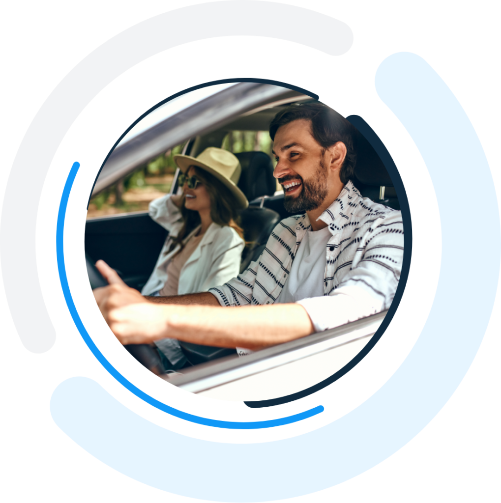 couple driving inside the one day insurance logo