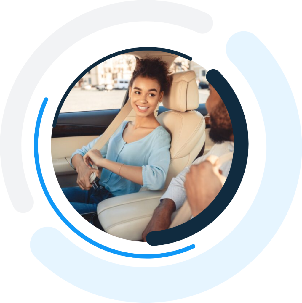 couple chatting inside of a car inside the one day insurance logo