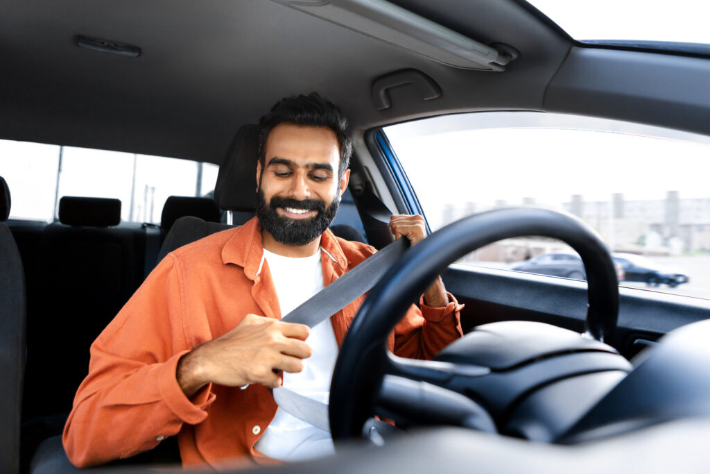 Indian Driver Man Putting On Seat Belt For Car Trip