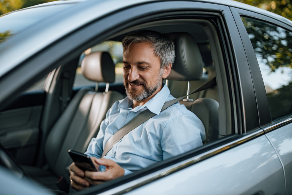 Man using phone while sitting in the car.